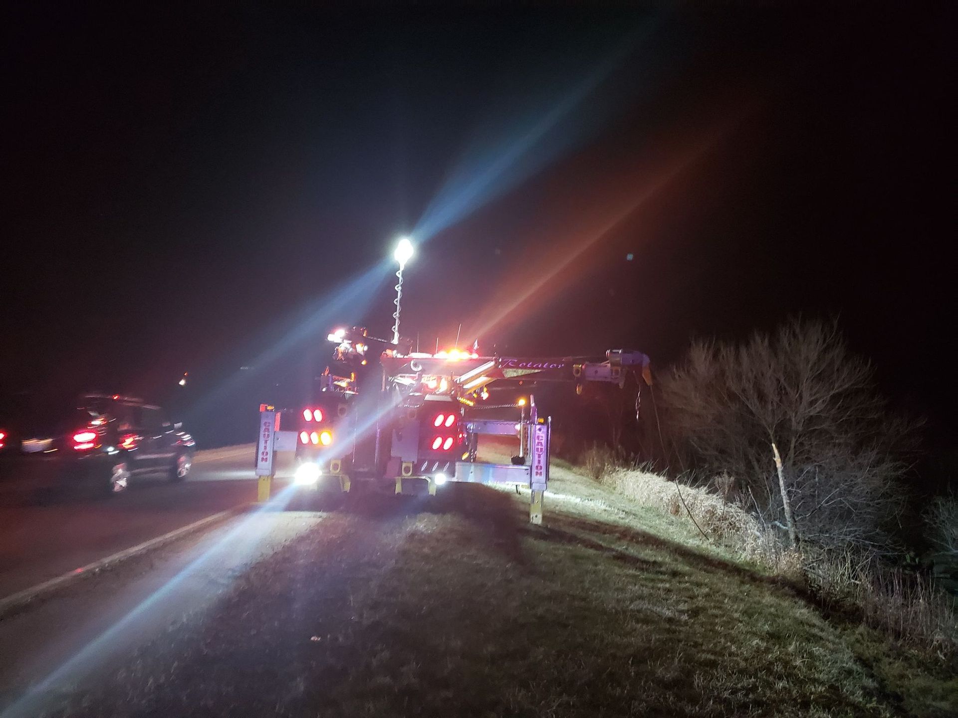 Night roadside recovery scene with emergency lights
