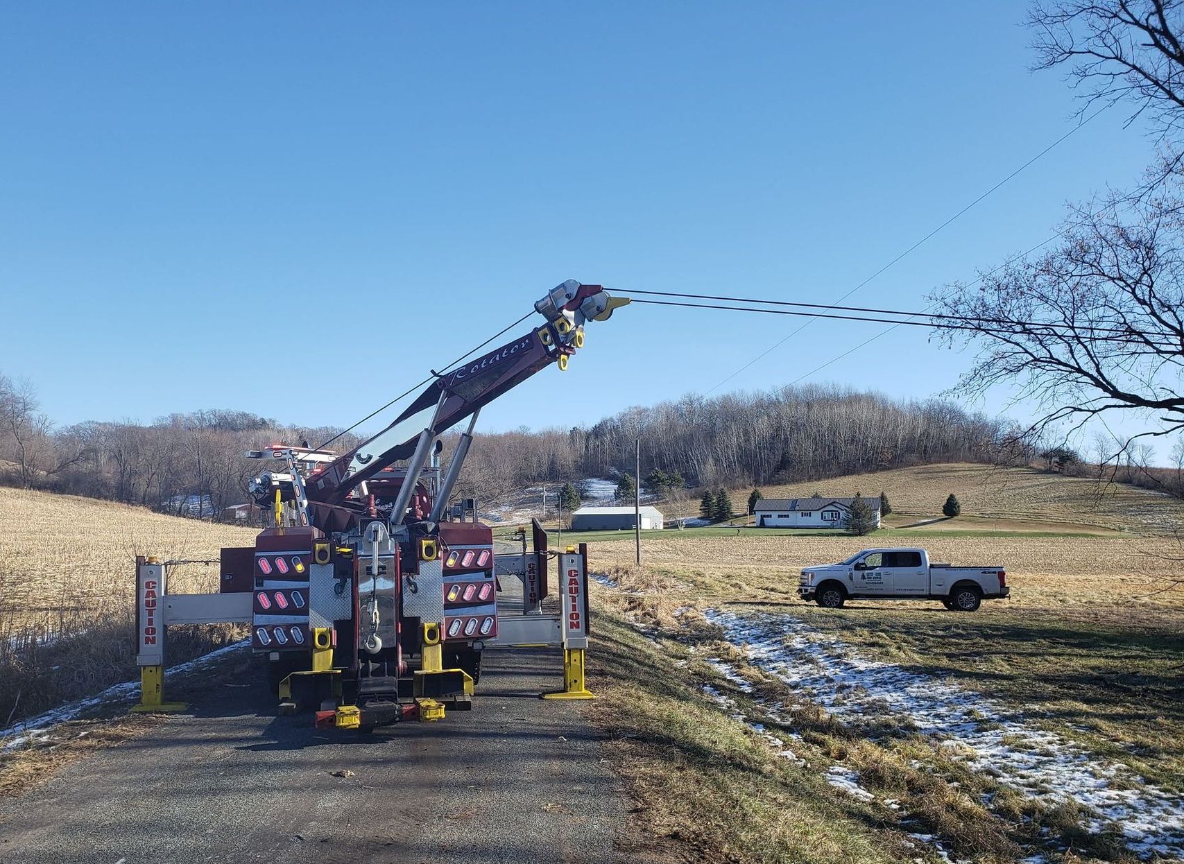 Heavy-duty tow truck winching a vehicle out of a field