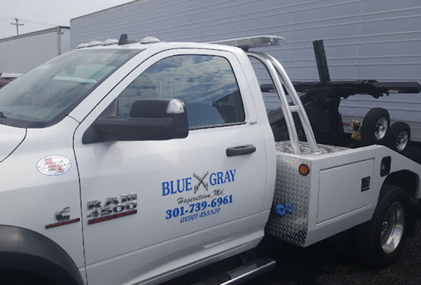 White pickup tow truck with Blue Gray door lettering and tool boxes