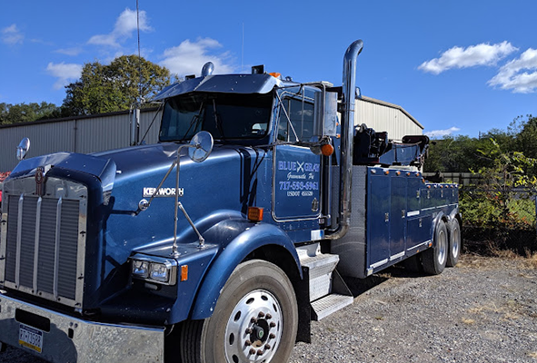 Dark blue Kenworth heavy wrecker with Blue Gray lettering