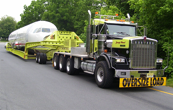 Lowboy trailer hauling an oversize load